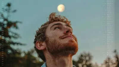 A man gazes upward at the night sky, with the moon visible in the background.